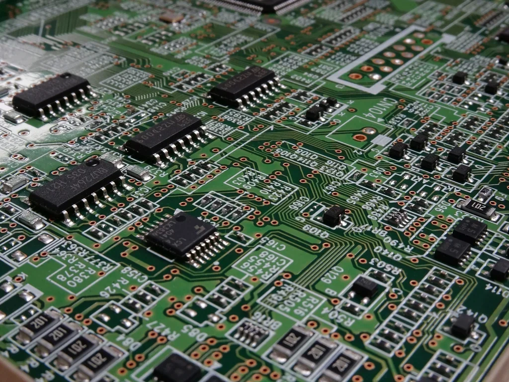 Green FR-4 PCB with surface-mount components and ICs