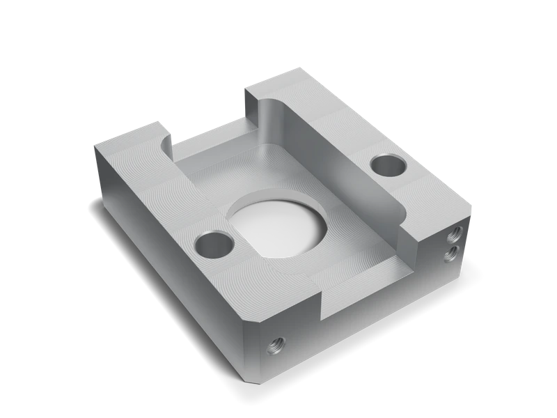 CAD render of a machined aluminum fixture base with a stepped pocket, mounting holes, side threads and fine facing marks.